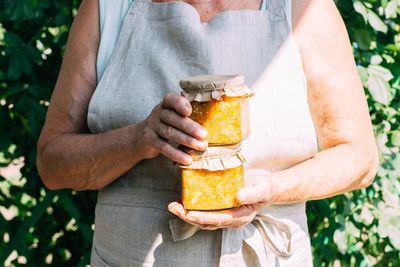 Midsection of woman holding drink