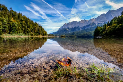 Scenic view of lake and mountains against sky