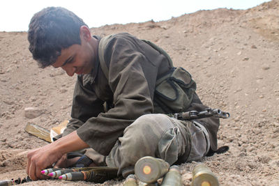 A child fighter supplies ammunition to his comrades