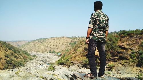 Rear view of man standing on land