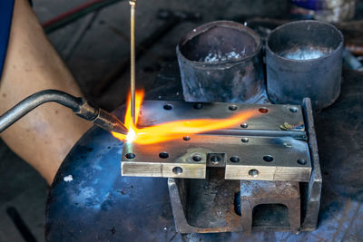 Cropped hand of worker welding metal