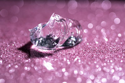 Transparent hyaluronic gel on a pink shining background.