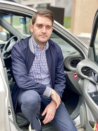 Portrait of man sitting in car