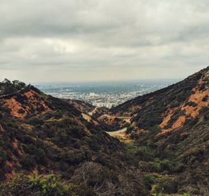 Scenic view of mountains against cloudy sky