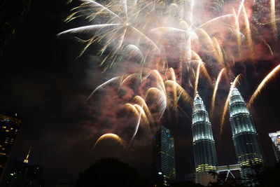 Low angle view of firework display at night