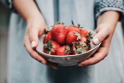 Midsection of person holding fruits