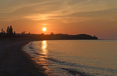 Scenic view of sea against romantic sky at sunset