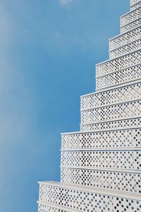Low angle view of modern building against clear blue sky