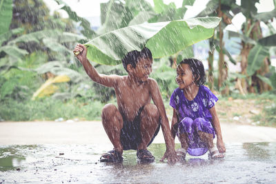 Full length of wet splashing water in rain