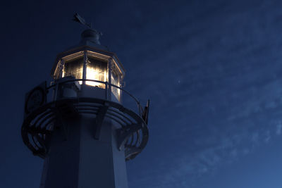 Low angle view of lighthouse against sky at night