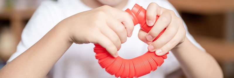 Anti stress sensory pop tube toys in a children's hands. a little kids plays with a poptube toy