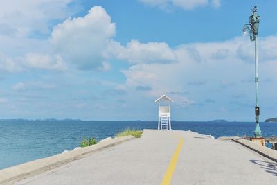 Lifeguard hut at beach against sky