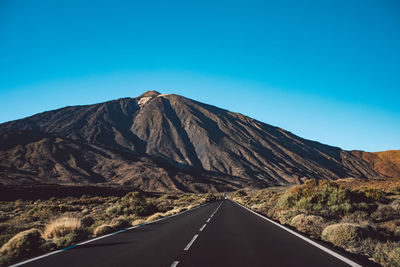 Mountain road against clear blue sky