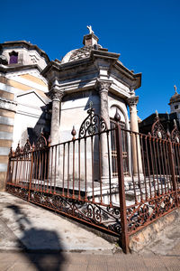 Low angle view of old building against clear blue sky