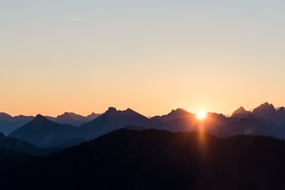 Scenic view of silhouette mountains against sky during sunset