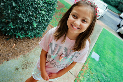 Portrait of smiling girl standing outdoors