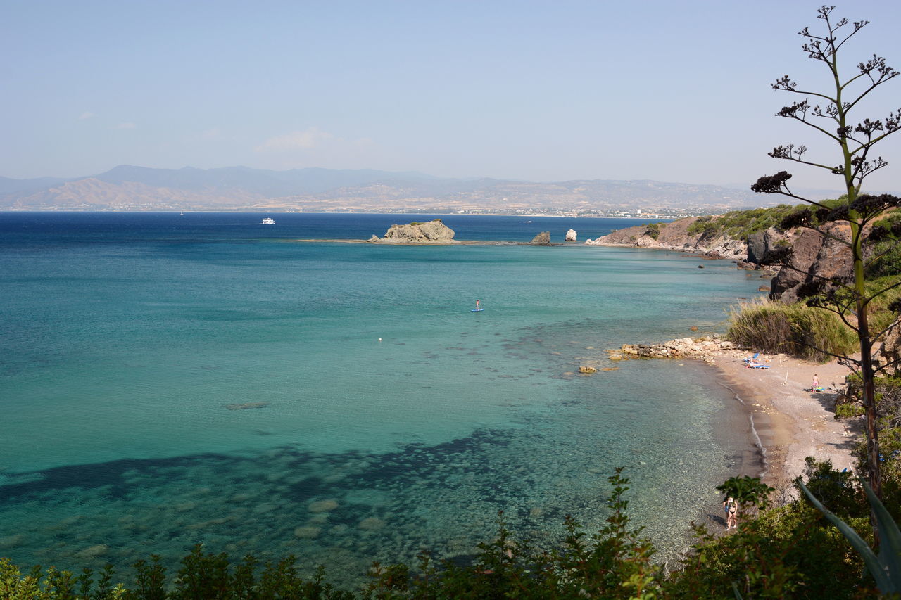 water, sea, land, sky, body of water, scenics - nature, beach, beauty in nature, nature, tree, coast, travel destinations, plant, shore, tranquility, travel, tranquil scene, ocean, blue, vacation, tourism, mountain, environment, coastline, clear sky, no people, idyllic, day, holiday, trip, bay, landscape, outdoors, non-urban scene, island, sunny, tropical climate, bay of water, cove, nautical vessel, terrain, sunlight, transportation, lagoon, horizon, sand
