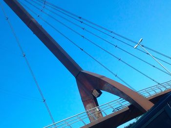 Low angle view of power lines against blue sky