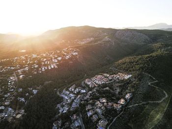 High angle view of houses on mountains against sky during sunset
