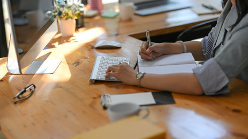 Midsection of businesswoman working at office