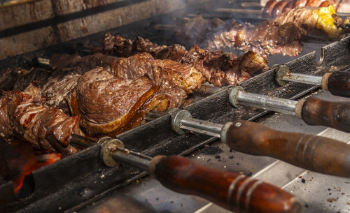 Brazilian style beef ribs barbecue grill on skewers at a churrascaria steakhouse in brazil.