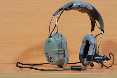 Close-up of headphones on wooden table