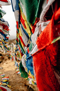 Close-up of multi colored flags hanging on rope