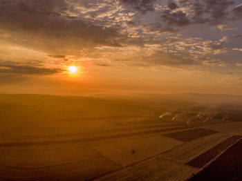 Scenic view of landscape against sky during sunset