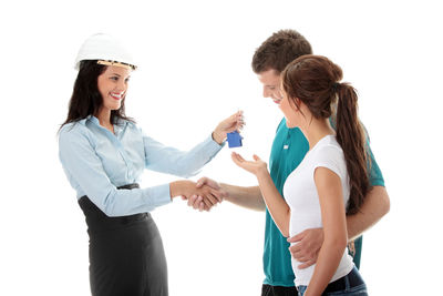 Friends standing against white background