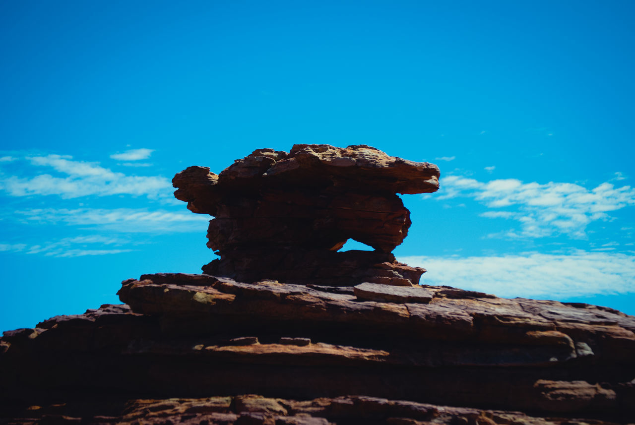 LOW ANGLE VIEW OF ROCK STACK AGAINST SKY