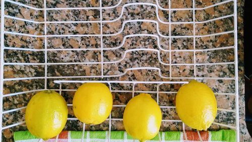 Close-up of fruits on table against wall