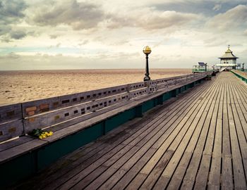 Pier over sea against sky