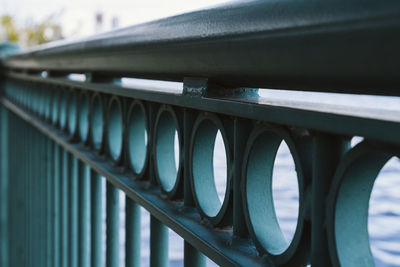 Perspective of green, urban, iron railing in a city. selective focus