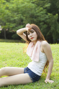 Woman sitting on field at park
