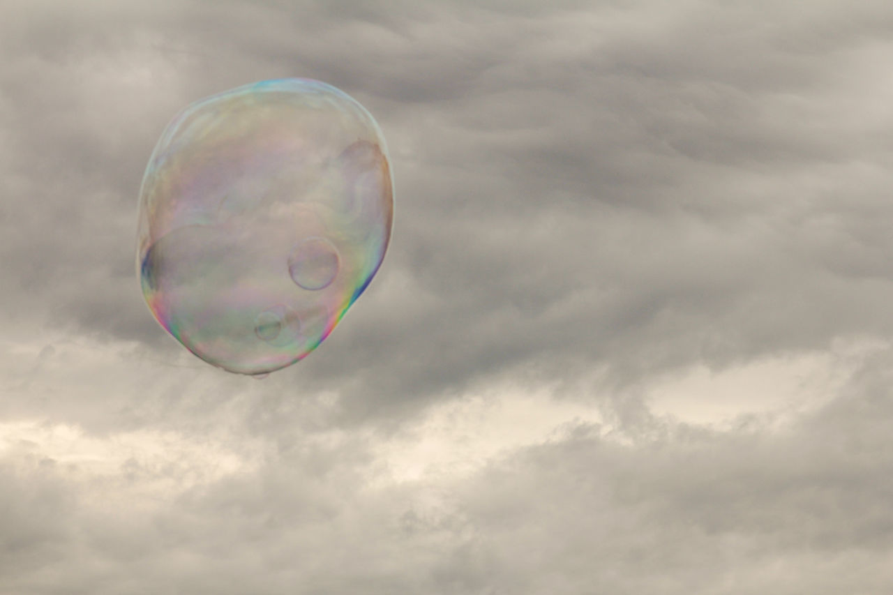 LOW ANGLE VIEW OF BUBBLE AGAINST SKY