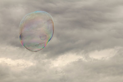 Low angle view of bubbles against sky