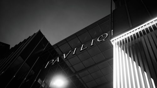 Low angle view of illuminated building against sky in city