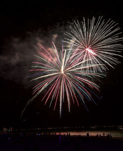 Low angel view of firework exploding at night in coney island