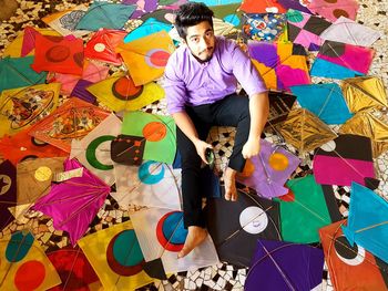 Low section of person with multi colored umbrellas