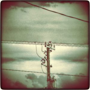 Low angle view of power lines against sky