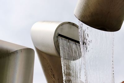 Low angle view of water pipe against sky