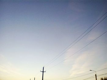 Low angle view of electricity pylon against sky