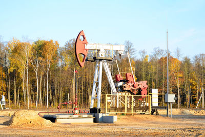 Metallic structure on field against sky