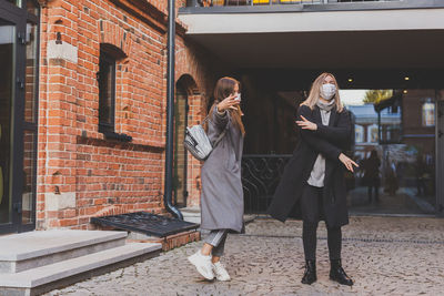 Rear view of woman using mobile phone