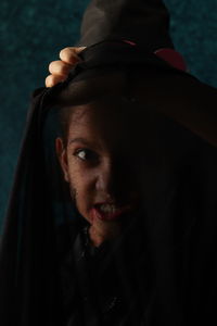 Close up of an angry girl looking through transparent fabric