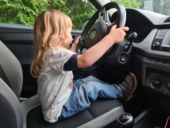 Side view of girl in car