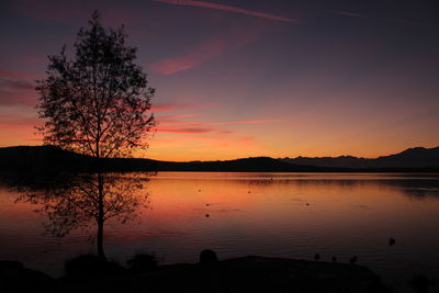 Scenic view of lake against orange sky