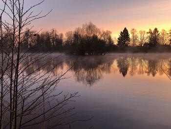 Scenic view of lake against sky during sunset