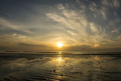 Scenic view of sea against sunset sky