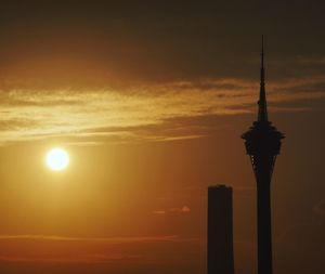 Silhouette tower against sky during sunset